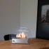 Circular tabletop fireplace wit glass panels on the sides